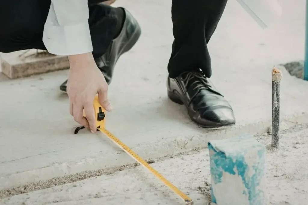 person measuring ground